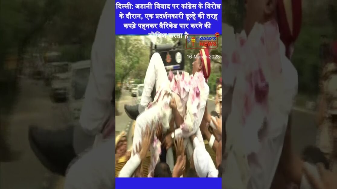 During Congress' protest over Adani row, one of the protesters, dressed like a groom tries to cross
